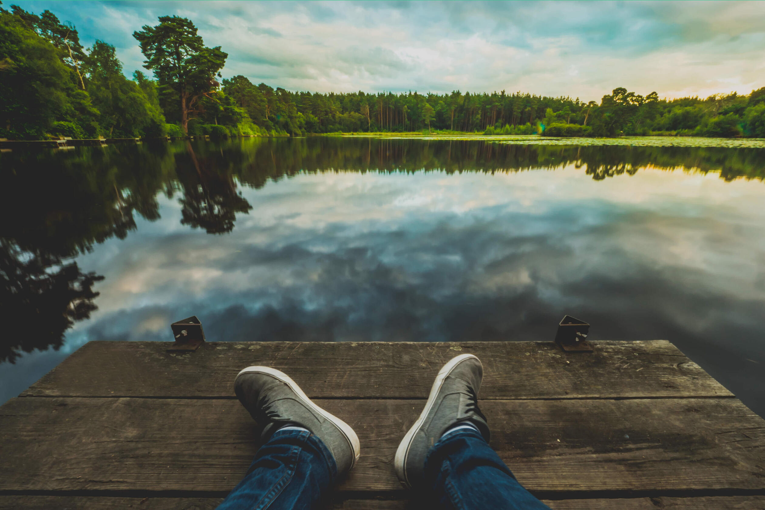 Person relaxing by a lake.